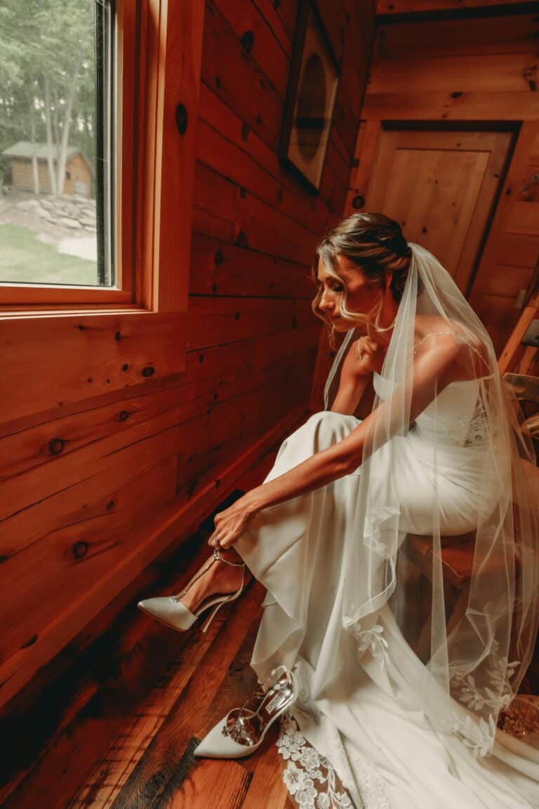 Bride putting on shoes on her wedding day